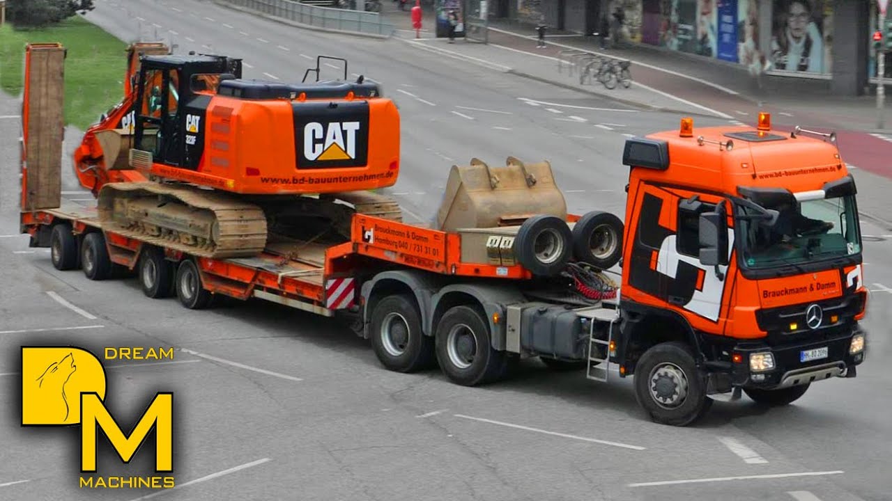 Caterpillar 323F excavator on the move to jobsite on lowboy trailer Mercedes heavy semi truck