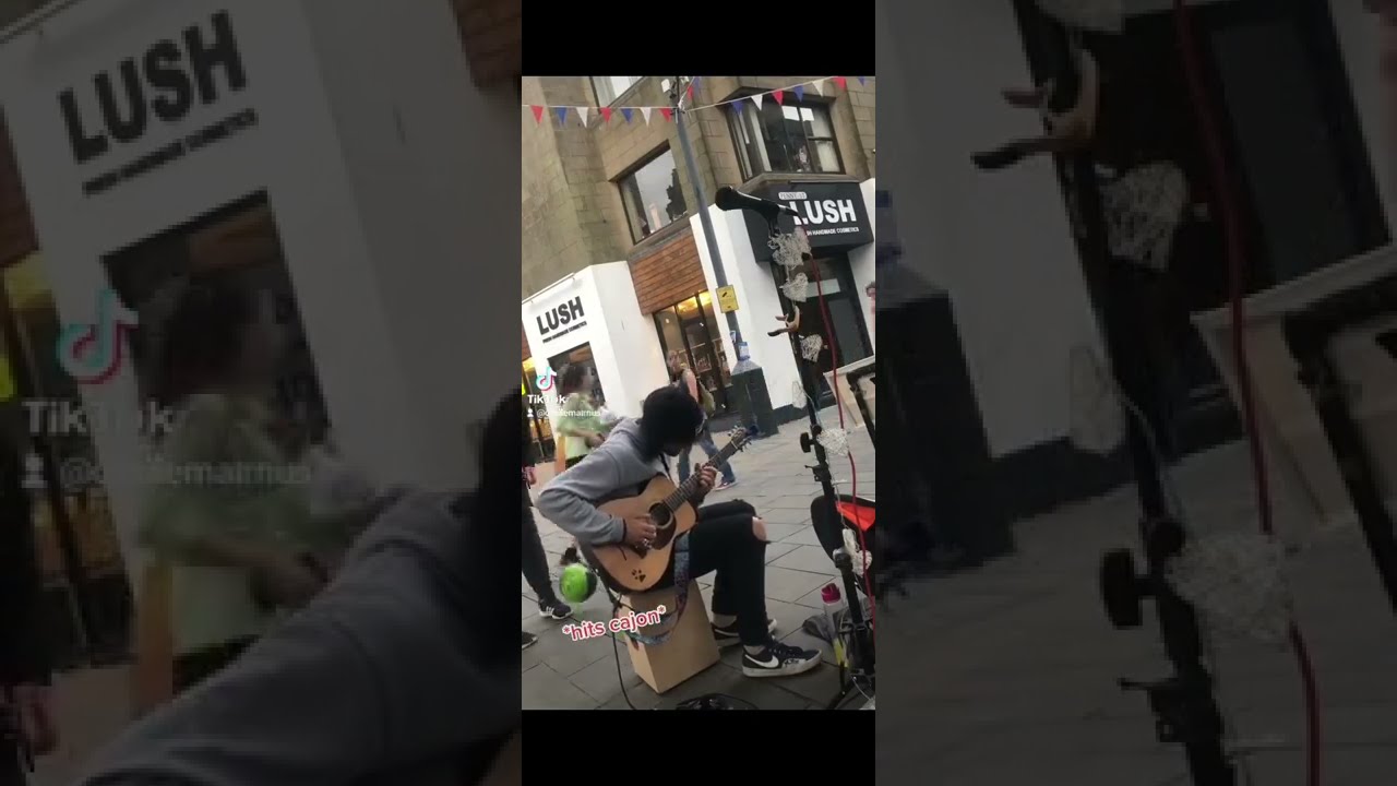 BUSKERS THREATENED AFTER FOOTBALL BREAKS CAMERA
