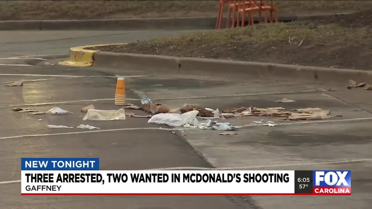 Three arrested, two wanted in McDonald's shooting