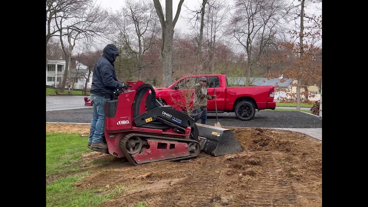 Spreading Top Soil with a Dingo 1000x Harley Rake Attachment