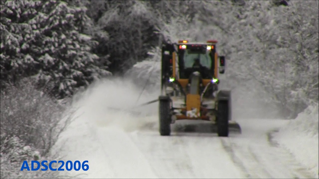 Volvo Motor Grader Plowing Fluffy Snow