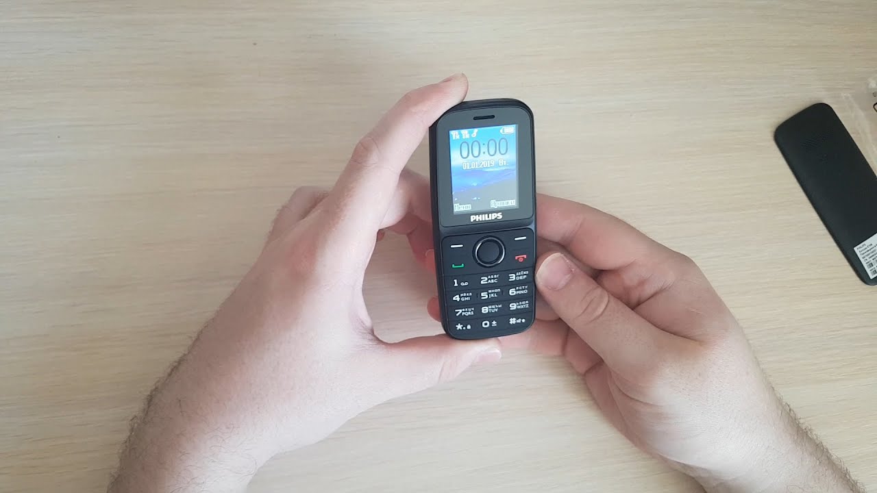 Распаковка Мобильный телефон Philips Xenium E109 Black из Rozetka