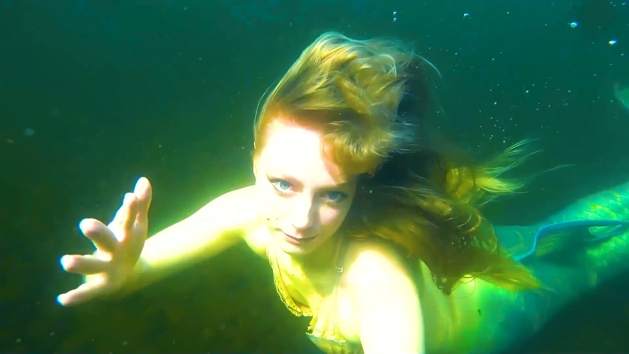 A Mysterious Mermaid Swims in a Lake under the Mountain