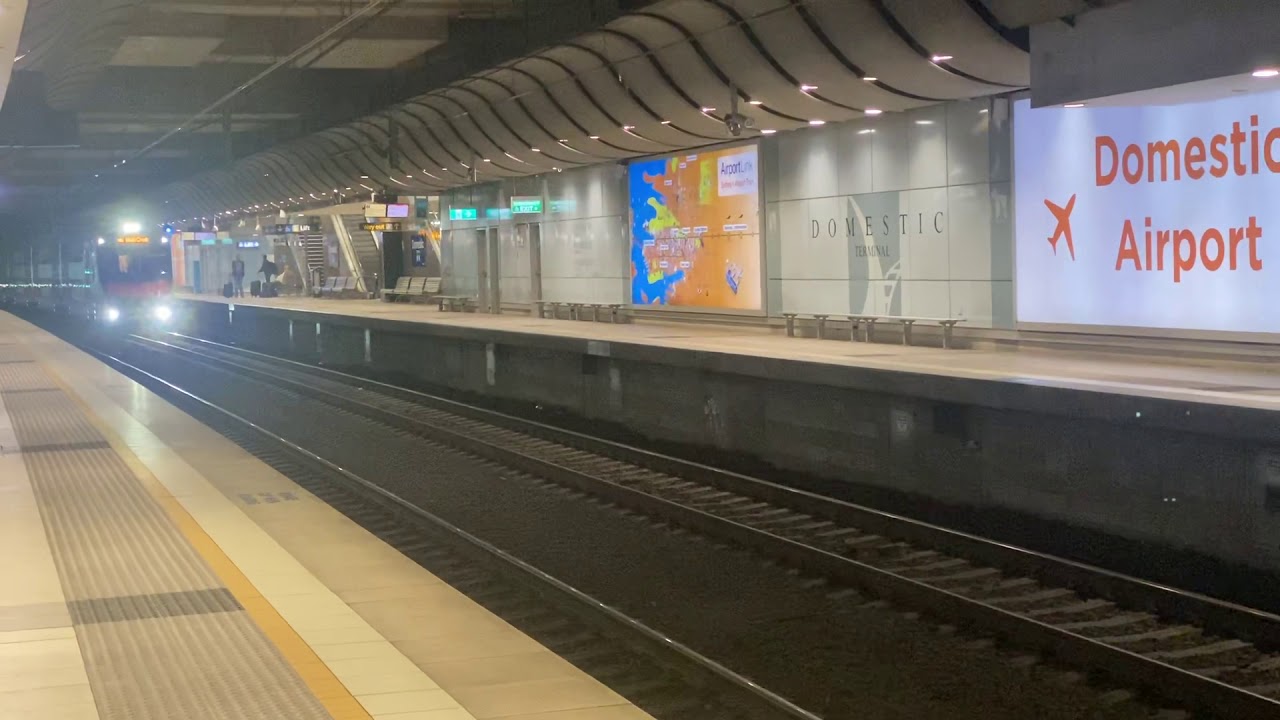 NSW Trainlink D set D103 passing Domestic Airport station Sydney.