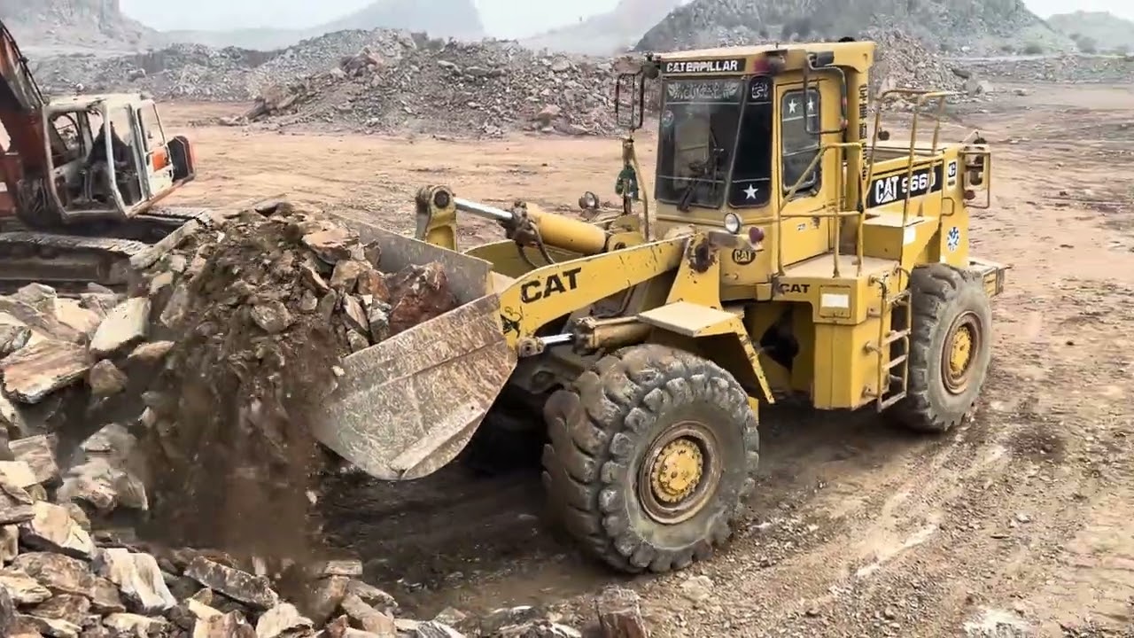 Caterpillar 966D Loader Heavy Stone Loading into Sino Dump Truck