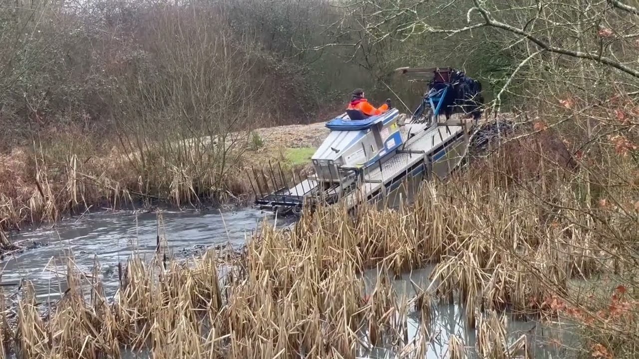 Truxor Removing Bulrush Reeds from a wildlife pond.