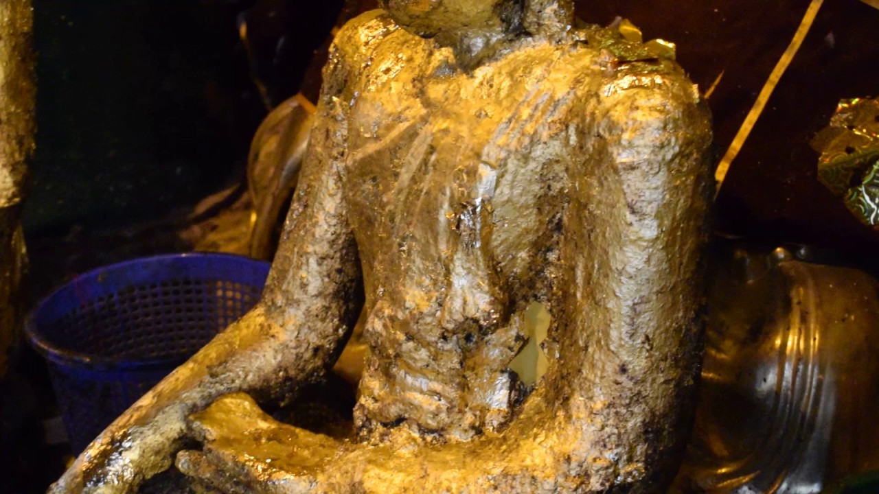 Shwedagon Pagoda-People rubbing gold leaf on the Buddha, www.AdventuresInWanderland.NET