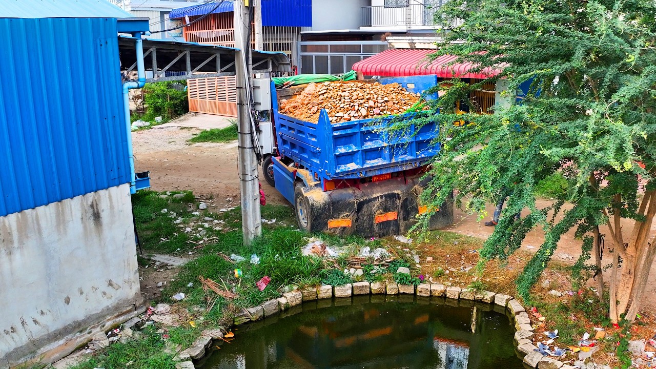 incredible landfill build factory for rend , truck transport soil , bulldozer push soil to water