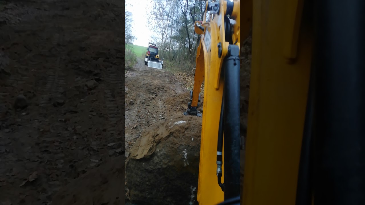 Wykopywanie kamienia na drodze polnej JCB 19 C-1