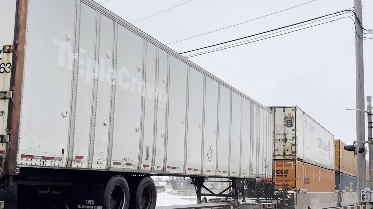 UP7382 East in DeKalb with Ex Triple Crown Trailer