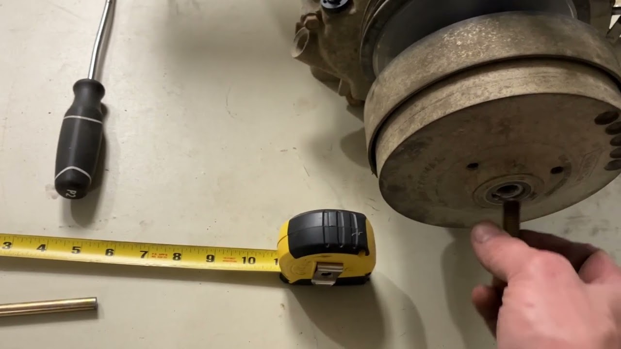 Removing the centrifugal pulley from a Kawasaki club car golf cart.