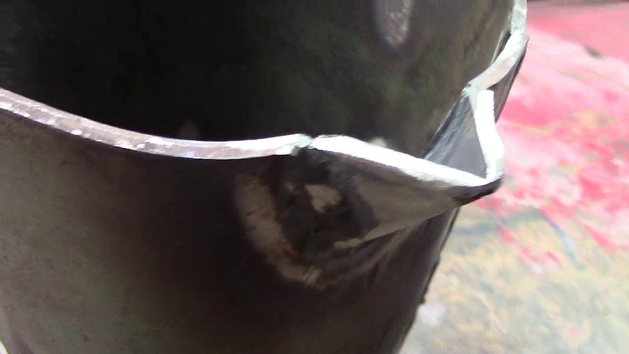 Manufacture of crucible with reinforcement for flame protection, pouring spout and safety support.