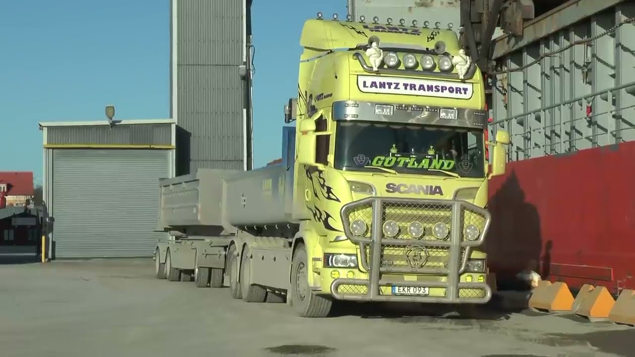 CAT Excavator loading sand at Scania and Mercedes trucks in Visby Port mars 2017