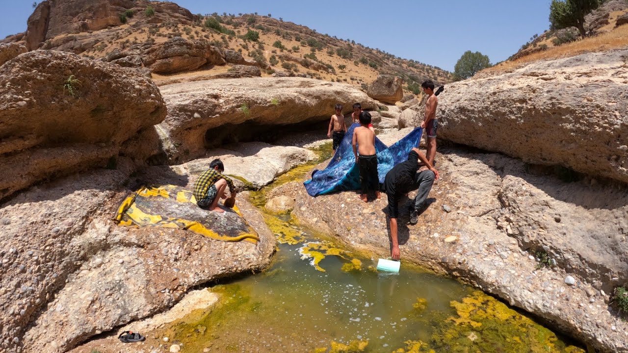 Documentary of going to the river and washing blankets and carpets