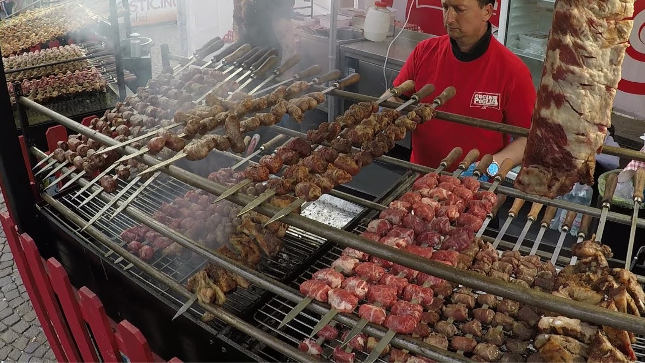 Italy Street Food. Pig Knuckles, Lamb, Pork Skewers, Melted Cheese, Focaccia, Dry-Cured Ham, Paella