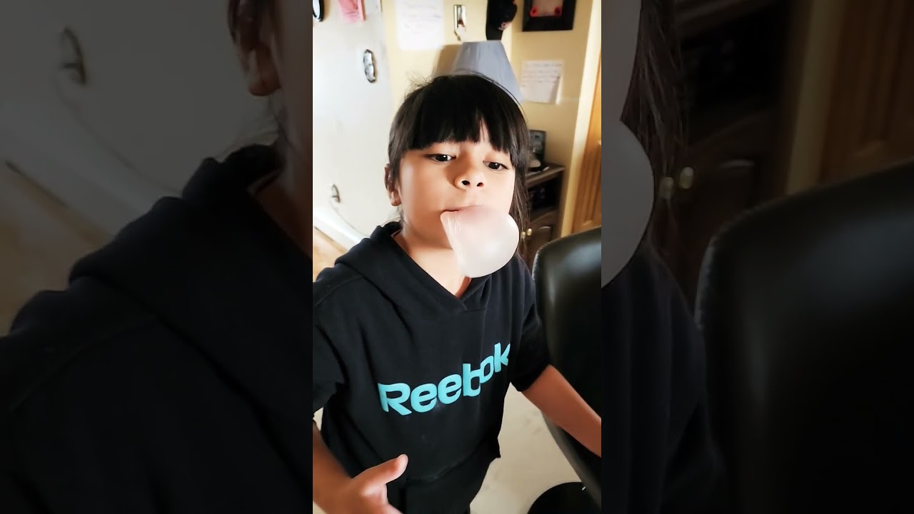 my 8 years old girl blowing bubble gum