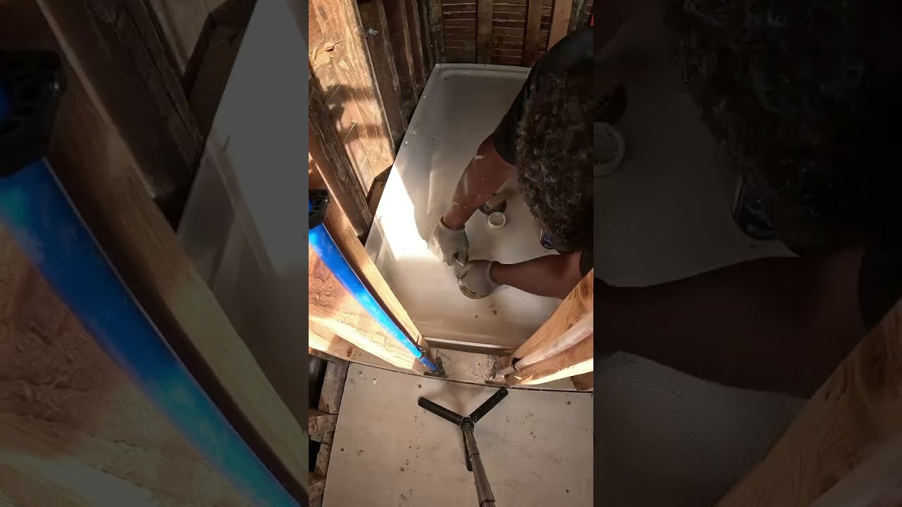 Installing  shower pan  base with quick set mortar.