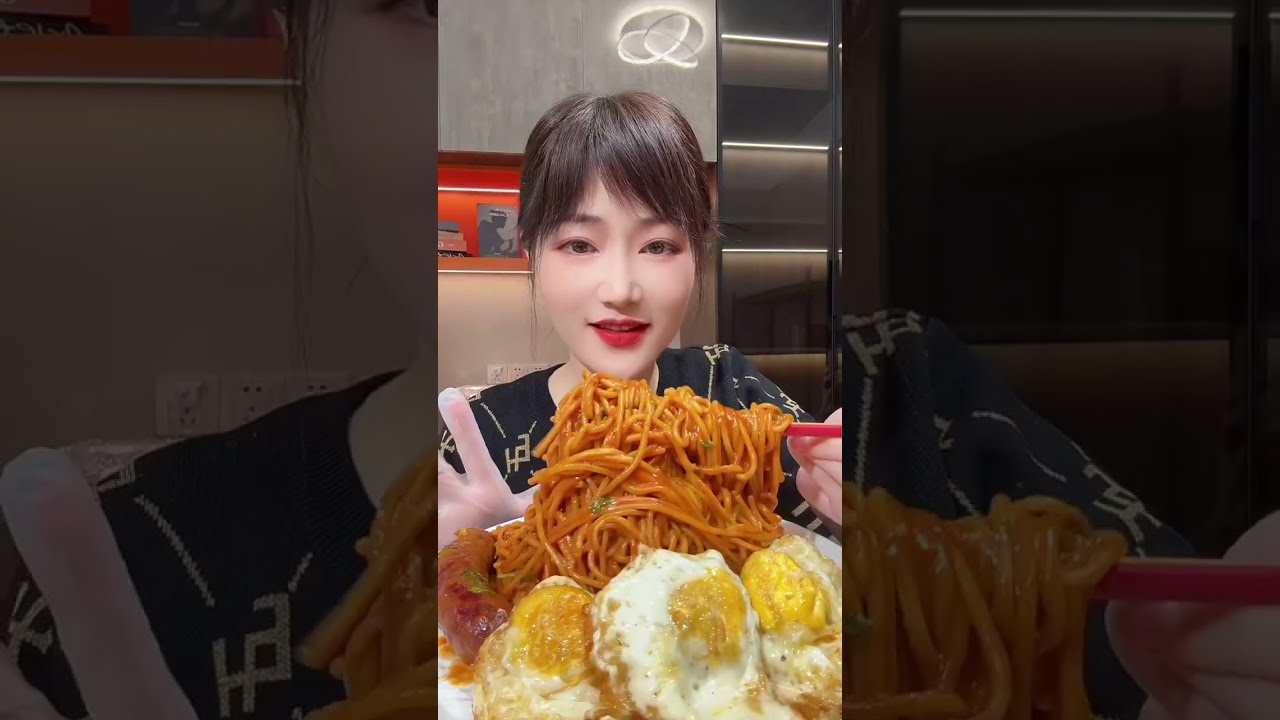 Eating delicious noodles fried eggs and sausage 