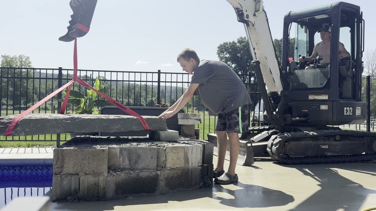 We built a natural stone waterfall with fire into our pool