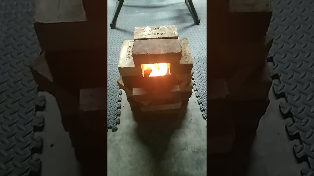 inside homemade heater, on concrete and ceramic base with firebricks/ toilet paper, can,70% alcohol