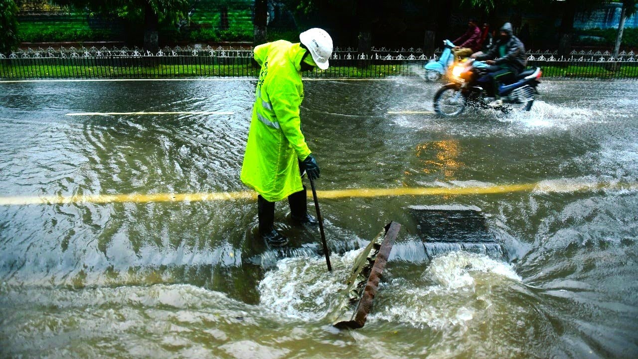 Unclogging storm drains to relieve flooded streets and back pressure caused by blockage further down