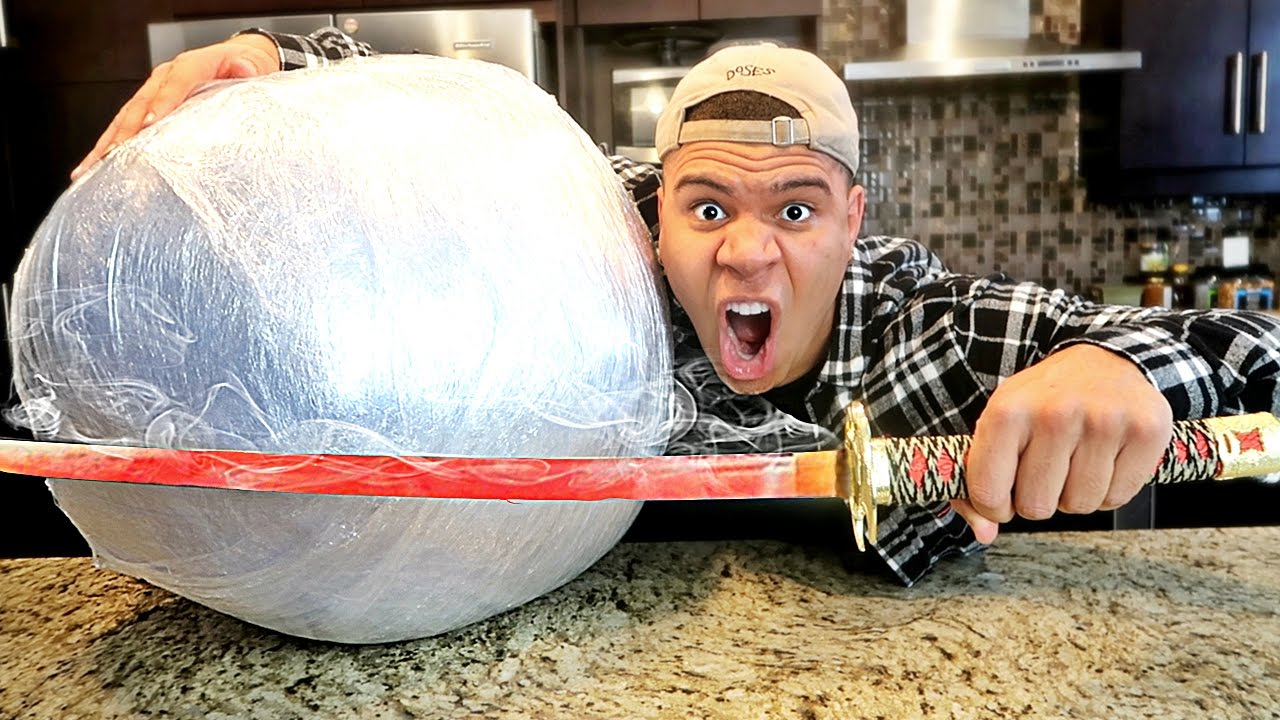 EXPERIMENT Glowing 1000 degree KATANA VS GIANT PLASTIC WRAP BALL! (10,000 LAYERS)