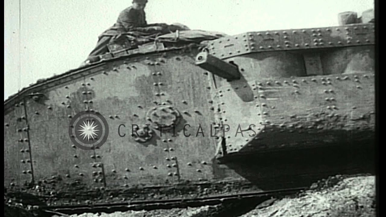 Mark I tank moves over a trench as soldiers sit on it during Battle of Arras in W...HD Stock Footage