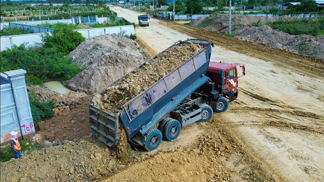 Amazing bulldozer and dump trucks work leveling on the road foundation
