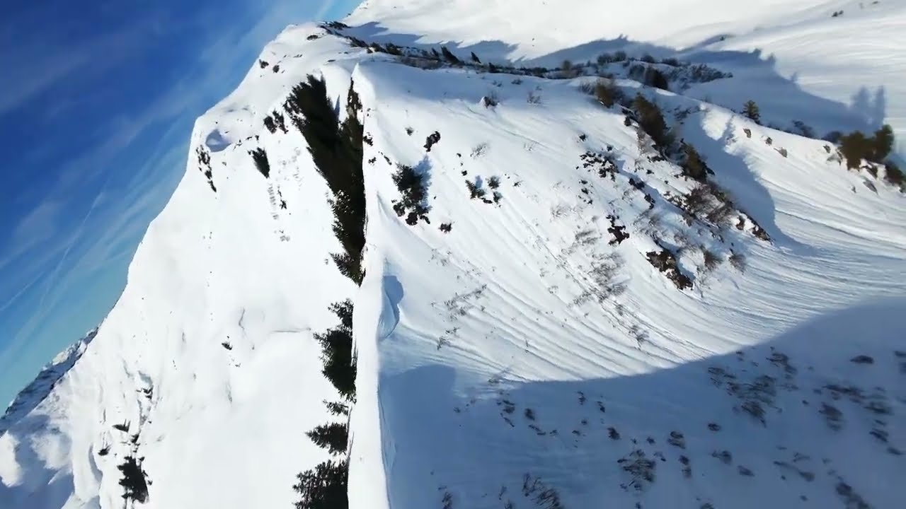 Oberdam&uuml;ls-Dam&uuml;ls, snowy mountain drone flight, Vorarlberg Austria