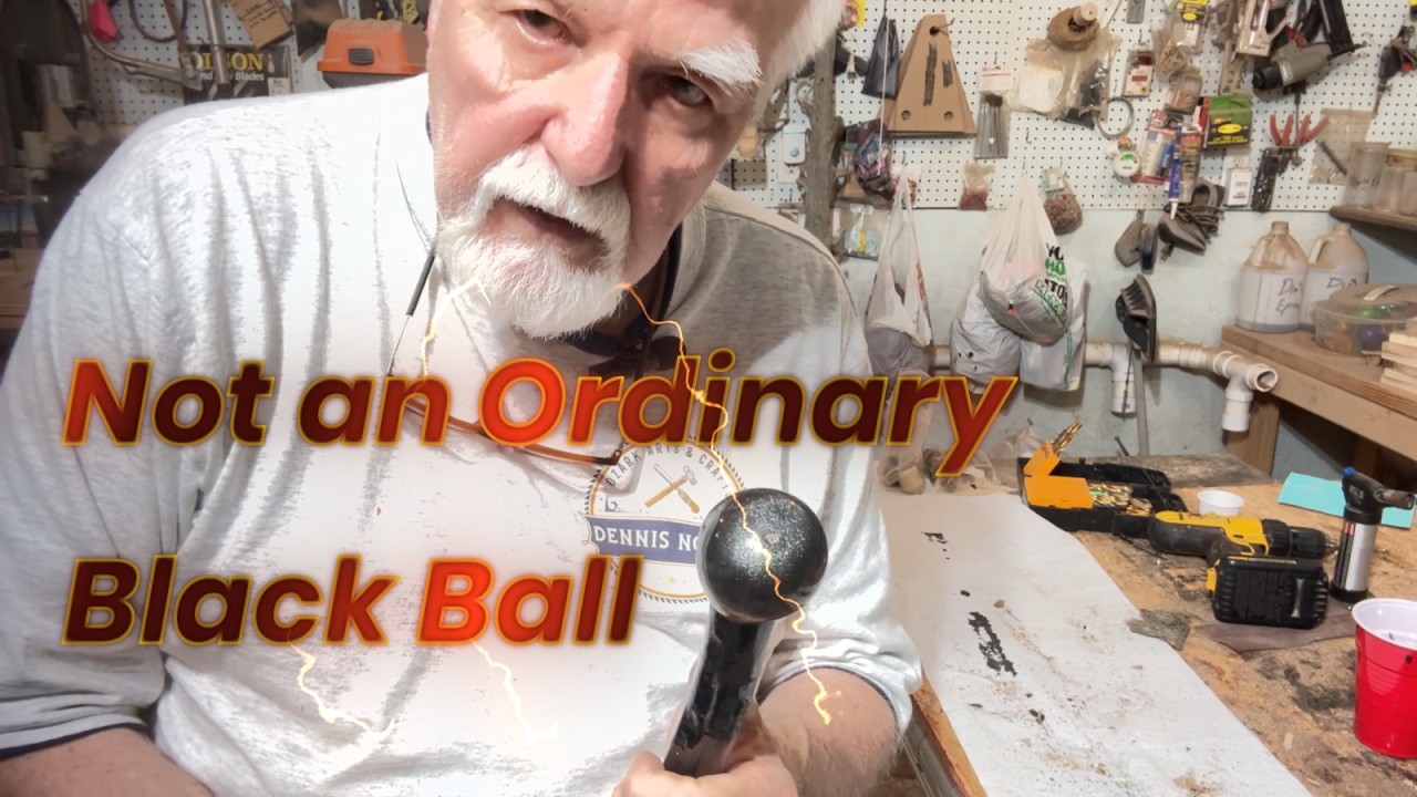 A Black Walking Stick with a Black Skull