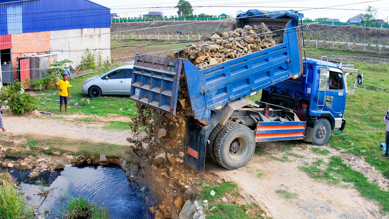 THE SKILL DRVER USE BULLDOZER PUSHING THE STONE and dump truck unload for level up land flood