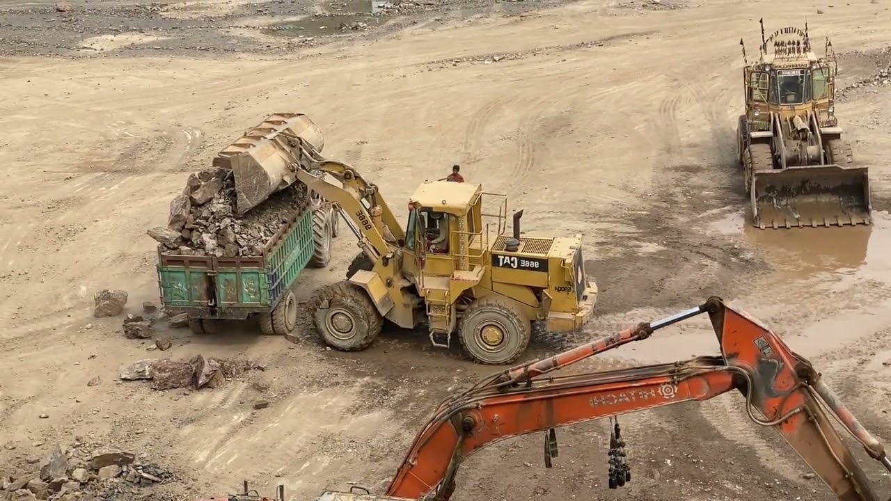 ۔Massive rocks loading with caterpillar machine heavy equipment in action