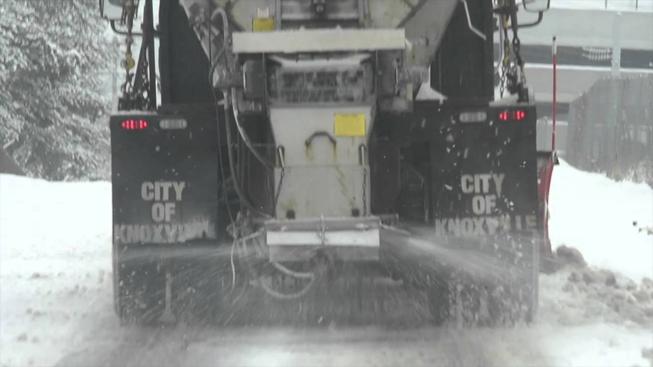 Salt trucks and plows clear snowy roads