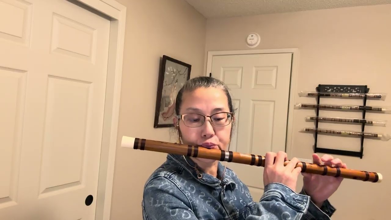 Toothless lady is learning to play the bamboo flute 