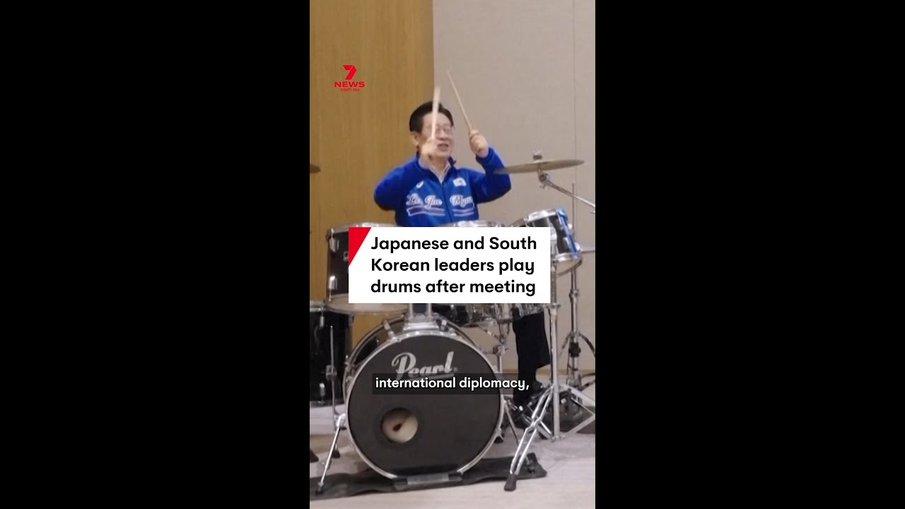 Japanese and South Korean leaders play drums after meeting