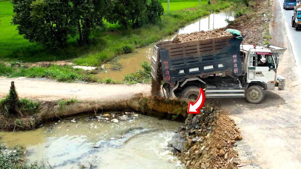 Nicely dump truck 5T unloading soil landfilling build road with bulldozer working push soil 