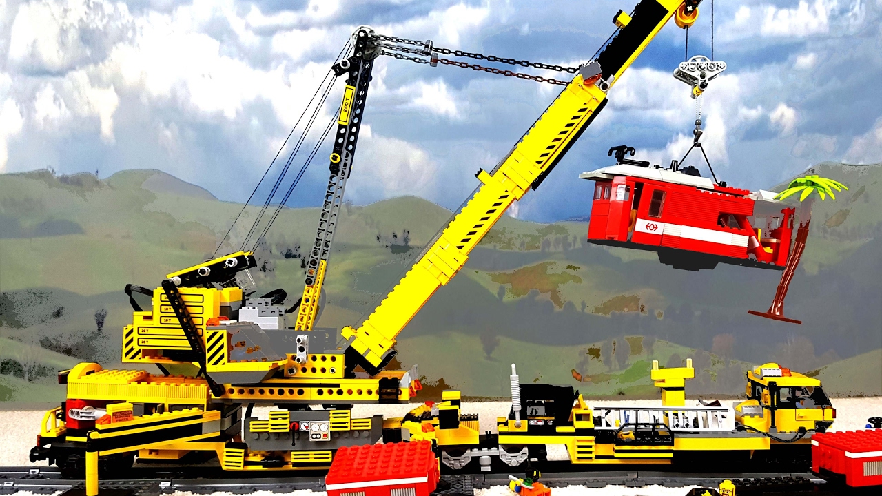 Big Lego train crane lifting locomotive after a heavy storm