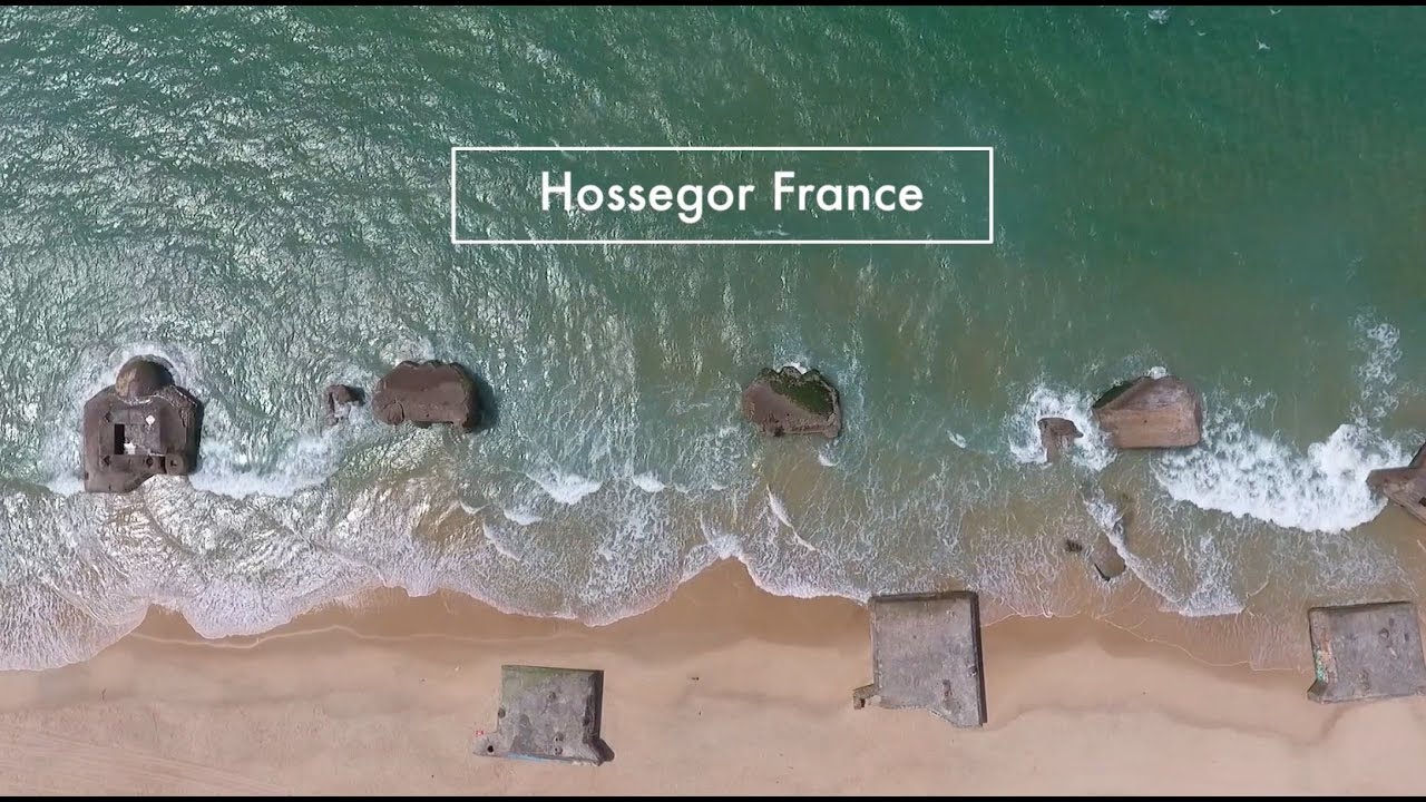 Fly drone above ocean Hossegor Aquitaine France - World War II bunkers in Capbreton, France