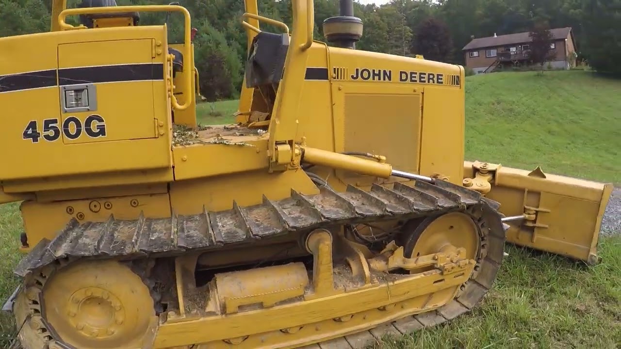 John Deere 450G. Clearing over grown land with bulldozer.