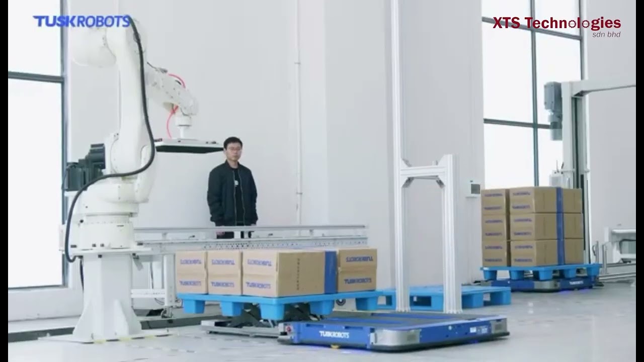 Pallet AGV  or AGF Tusk robotics pallet robot handling automation with conveyor and lift warehouse