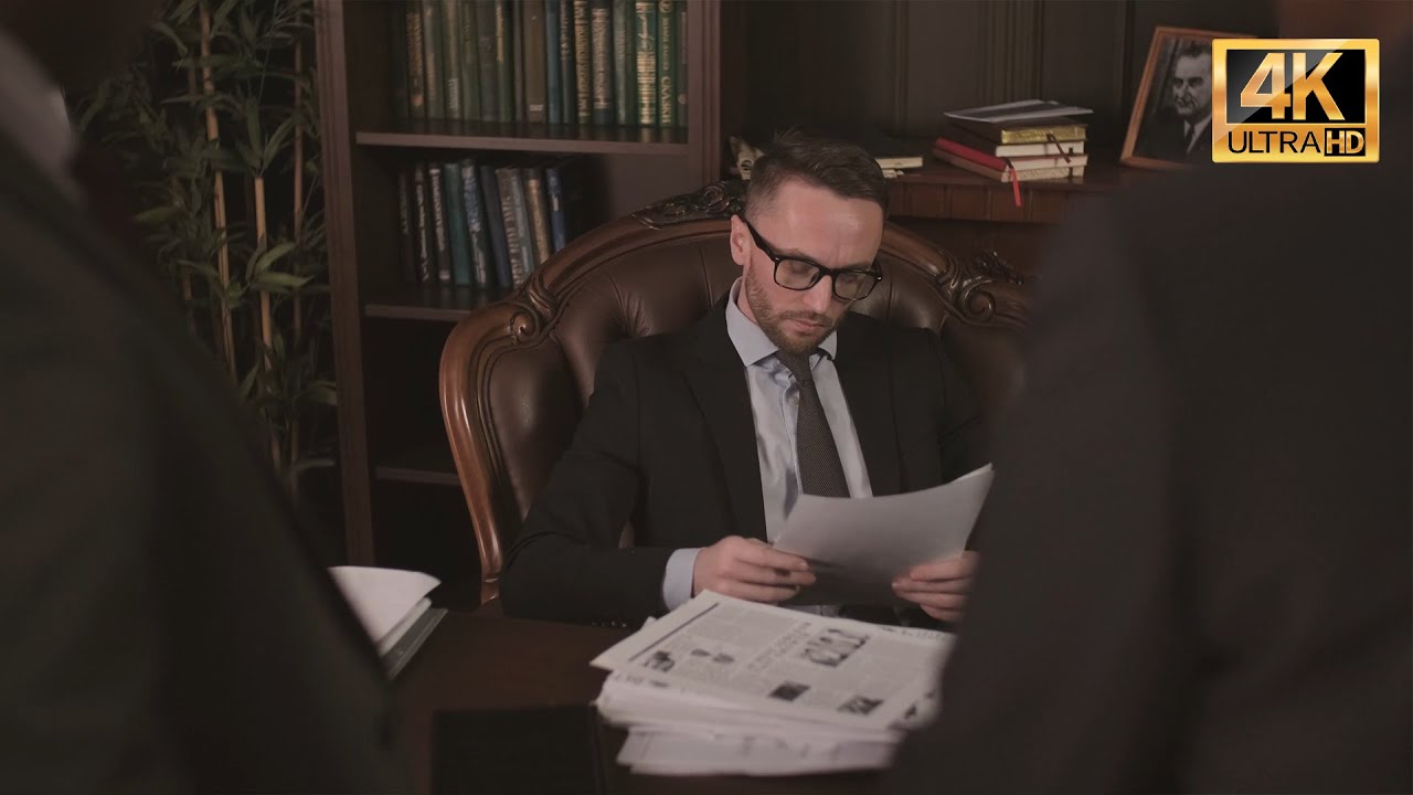 US Government Senior Official Reviews Documents in Formal Office Setting | 4K Stock Footage