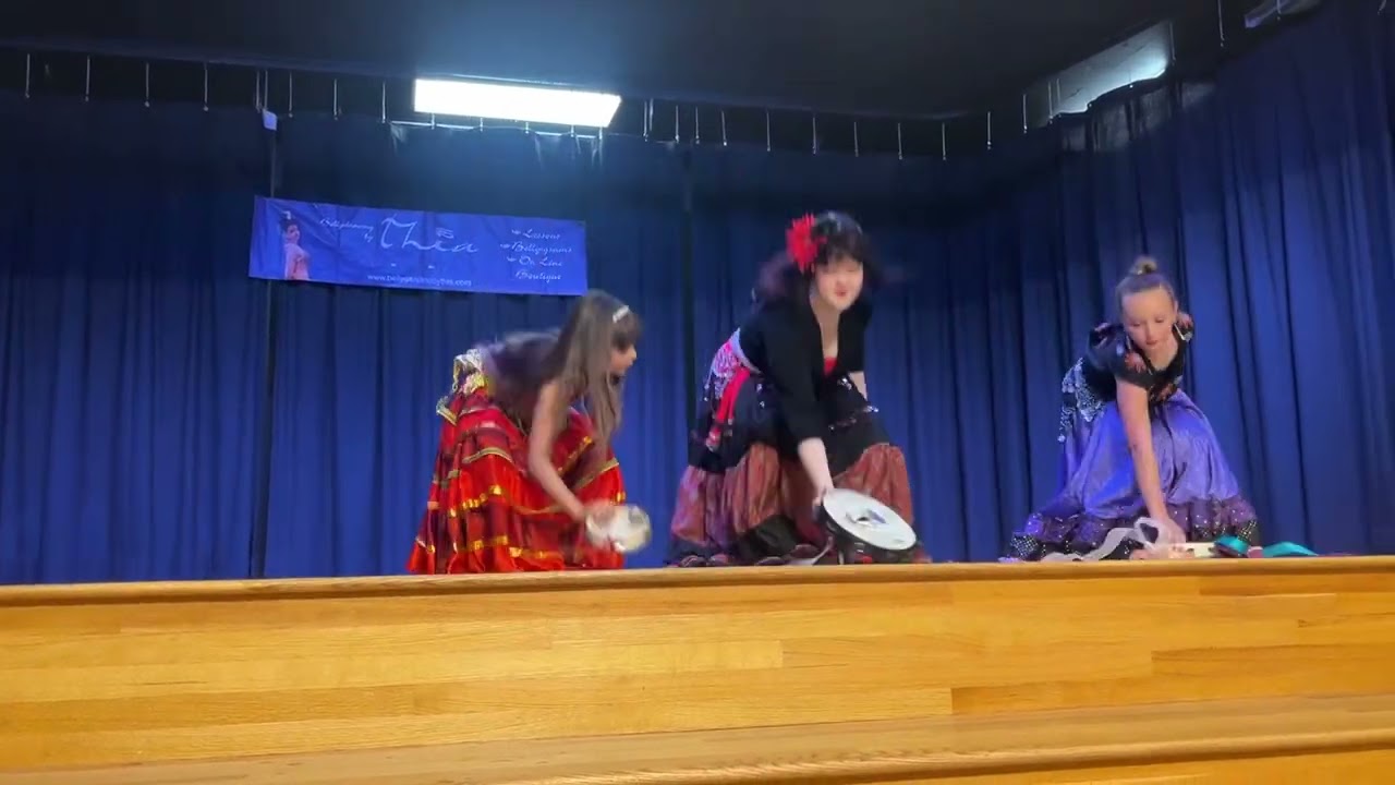 Pizzaz, Nova, and Tiny Tots doing their tambourine dance at the 2025 Bellydancing By Thia recital!