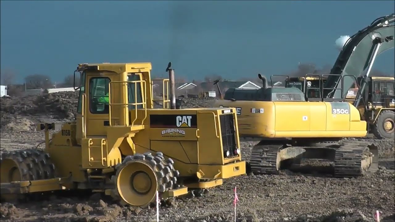 Steel Wheel Compactor, Excavator, and Bulldozer CAT D6 Working