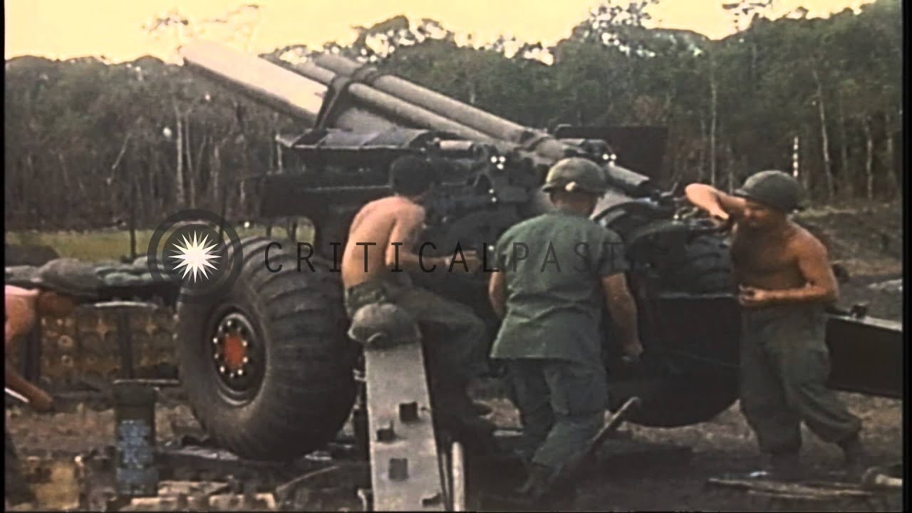 US soldiers load and fire a howitzer in a field at the Fire Support Base Bronco i...HD Stock Footage