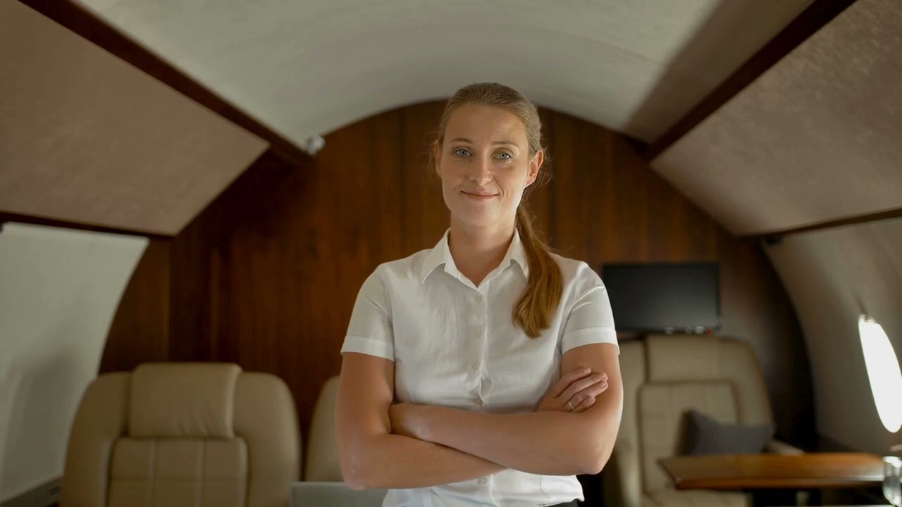 VideoVault Stock Video: Stewardess smiles in a private jet