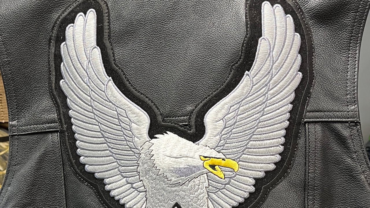 Sewing a patch on a leather vest