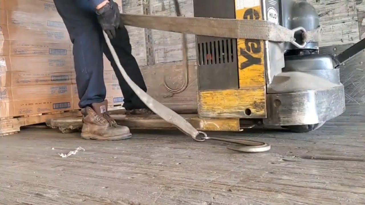 Using a power jack and a hook to remove  pallets loaded sideways