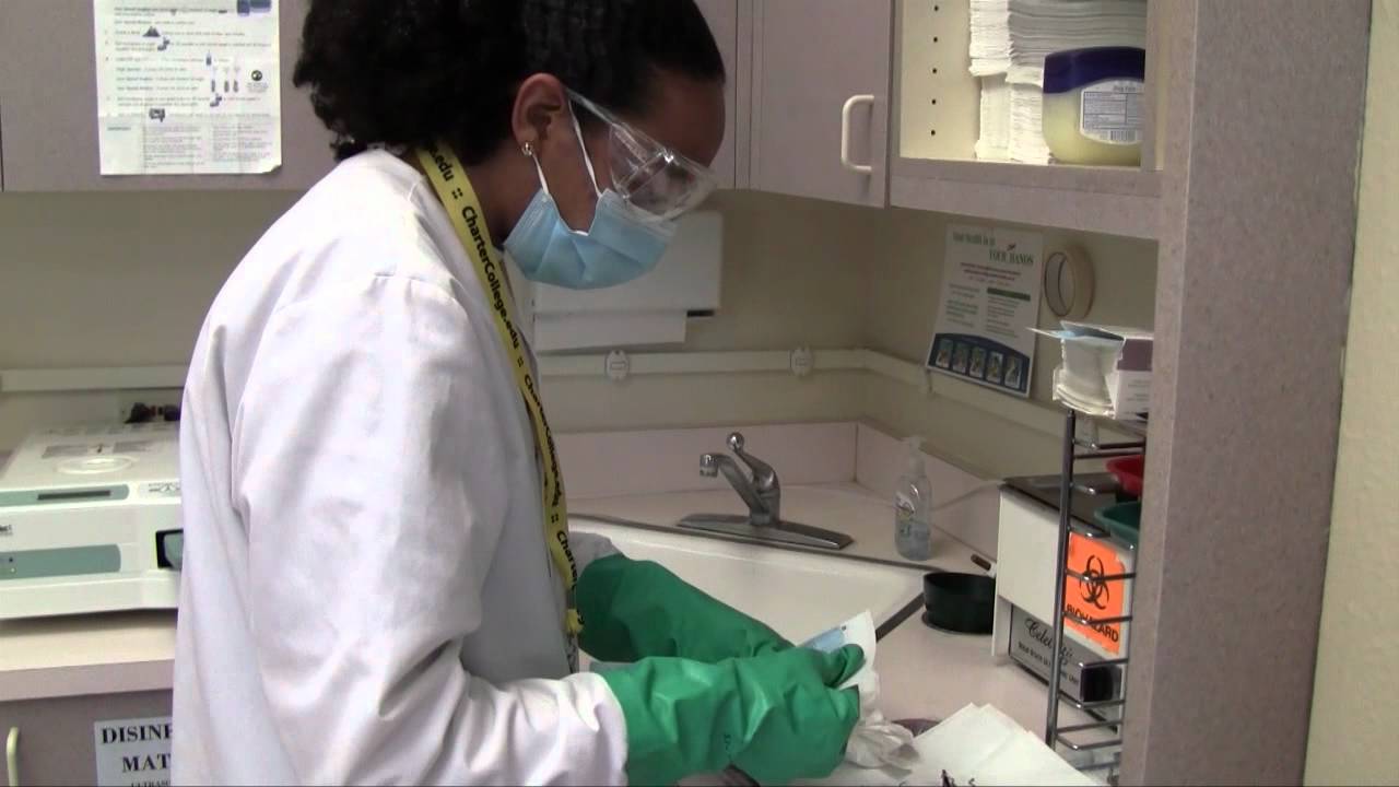 Dental Assistant Student Sterilizes Instruments - Charter College
