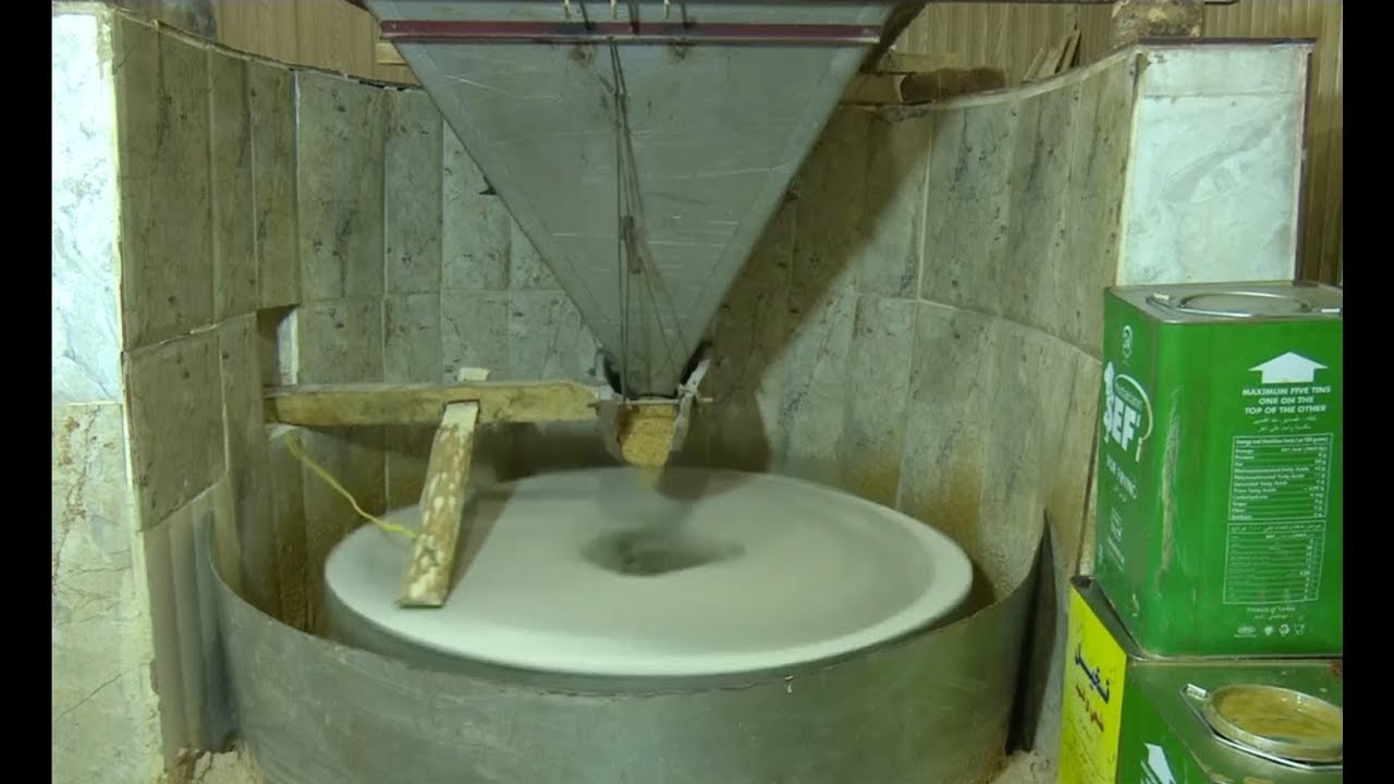 A Kurdish factory in Duhok uses the traditional grinder to crush the sesame seeds to produce tahini
