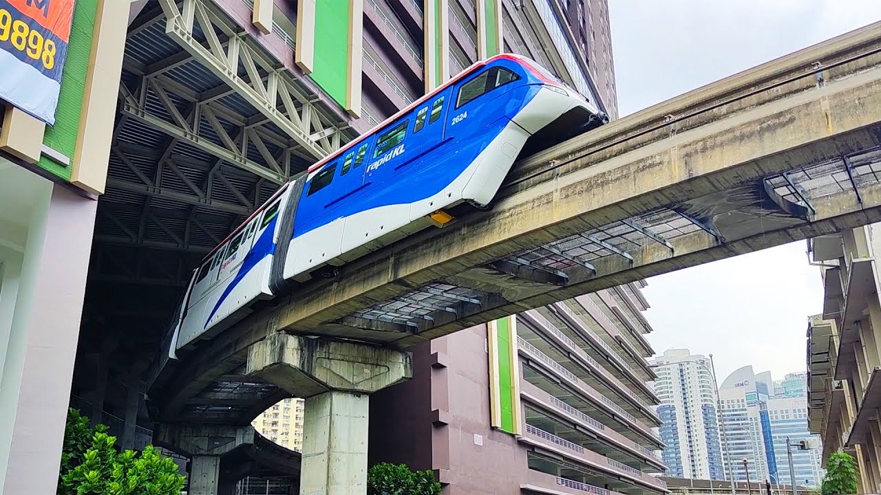 KL Malaysia Monorail train passes through residential building like Chongqing China